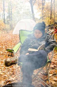 child reading by the campfire