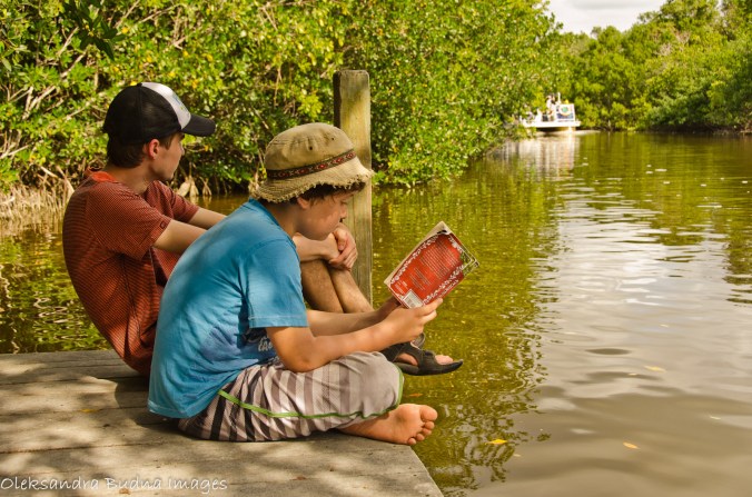 reading a book on the dock