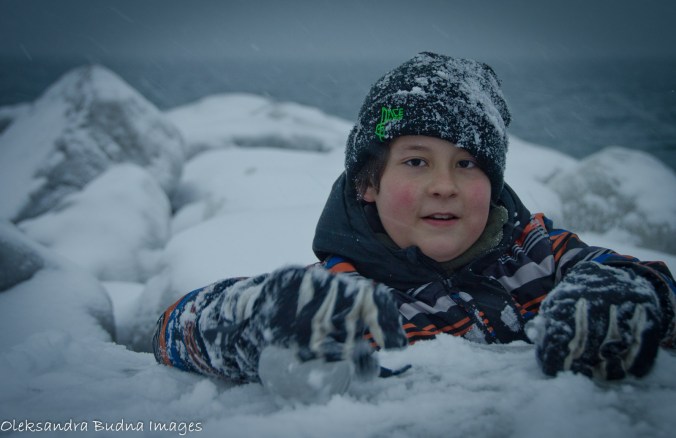 kid playing in the snow