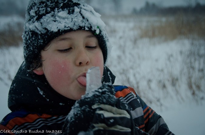 kid licking an icicle