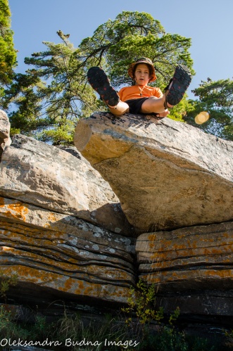 kid sitting on a rocky ledge at Killbear Provincial Park