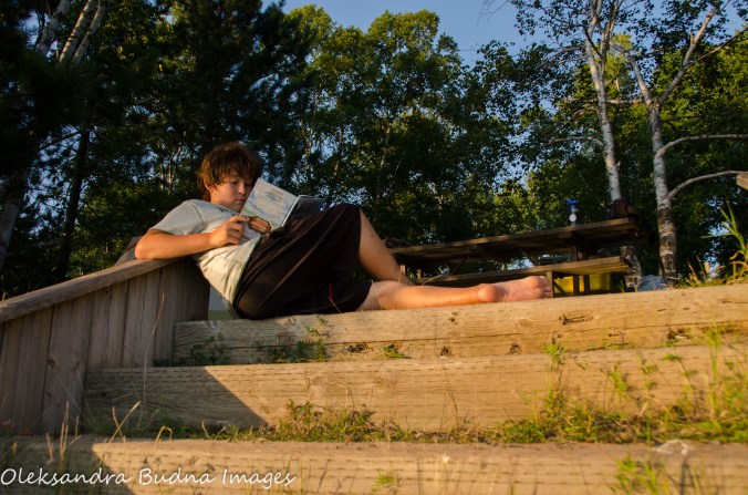 reading on the steps site 163 at Marie Louise Lake Campground at Sleeping Giant