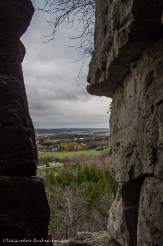 view of Lowville Valley through limestone cliffs at Rattlesnake Point