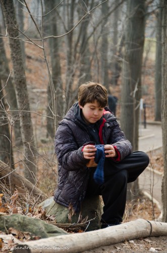 kid chaging a sock on the trail