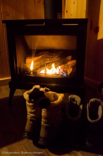 boots in front of a gas fireplace in a cabin in Killarney