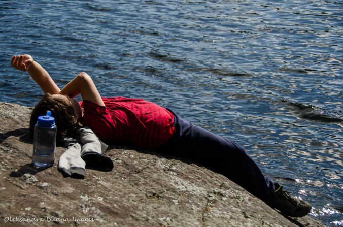 lying on the rock by the lak