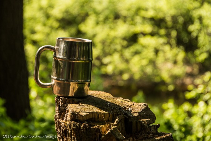 cup of coffee on a tree stump