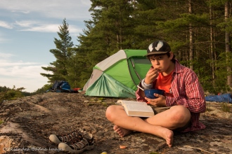 reading at a campsite