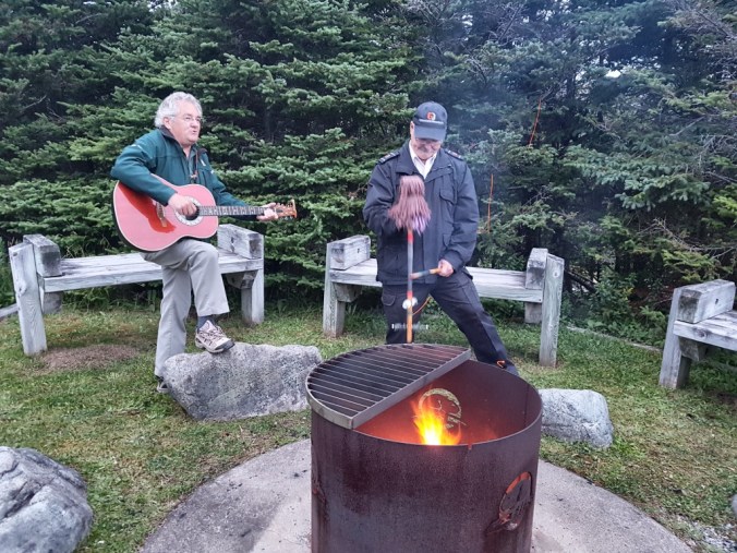 playing guitar and ugly stick in Gros Morne Park in Newfoundland
