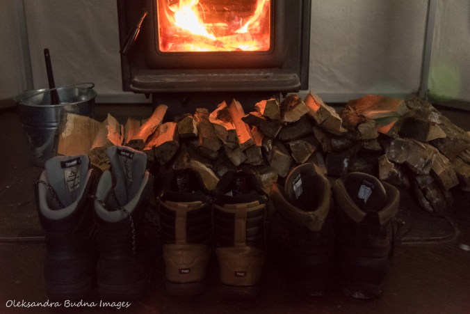 boots in front of a wood stove in a yurt in Silent Lake Provincial Park