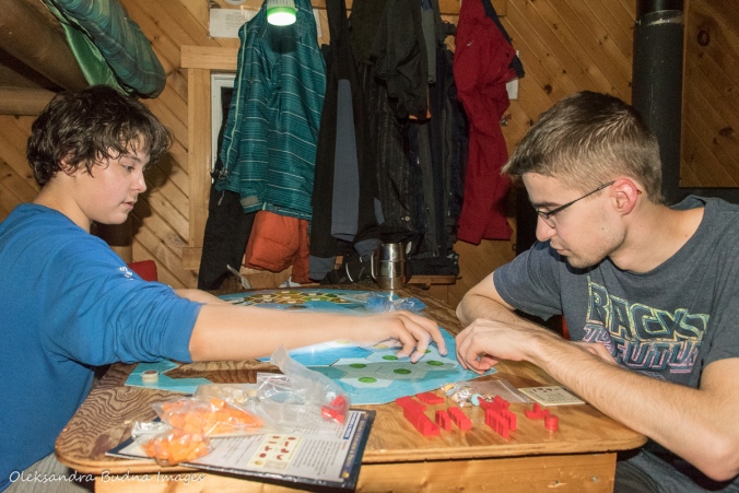 playing board games inside La Cigale rustic shelter in Parc National d'Aiguebelle