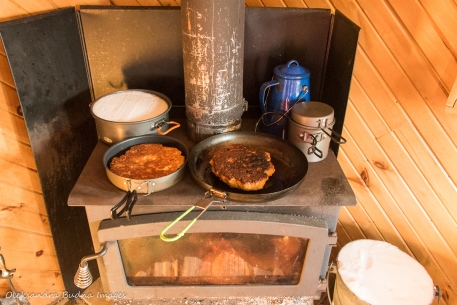 cooking on a wood stove in La Cigale cabin in Parc National d'Aiguebelle