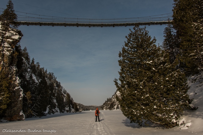 snowshoeing under suspension bridge on Lac La Haie in Parc National d'Aiguebelle