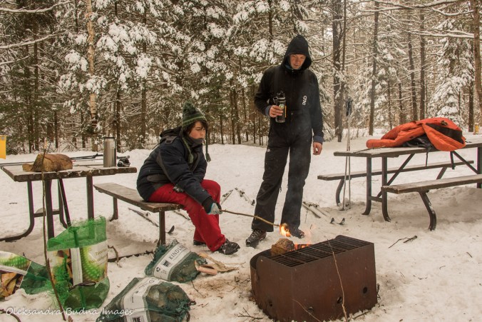 warming by the fire along the trail in Arrowhead Provincial Park in the winter