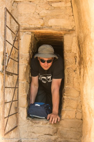 crawling through a tunnel at Balcony House in Mesa Verde