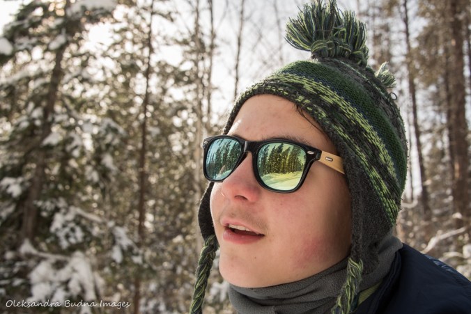 winter forest reflected in the sun glasses