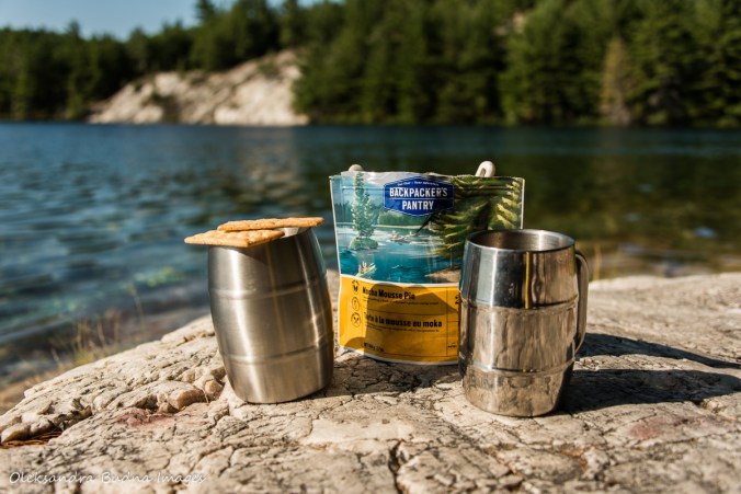 two cups of coffee and chocolate mousse near the lake on Nellie Lake in Killarney