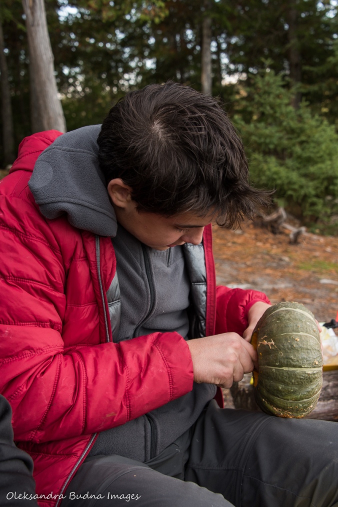 cleaning out a buttercup squash at a campsite