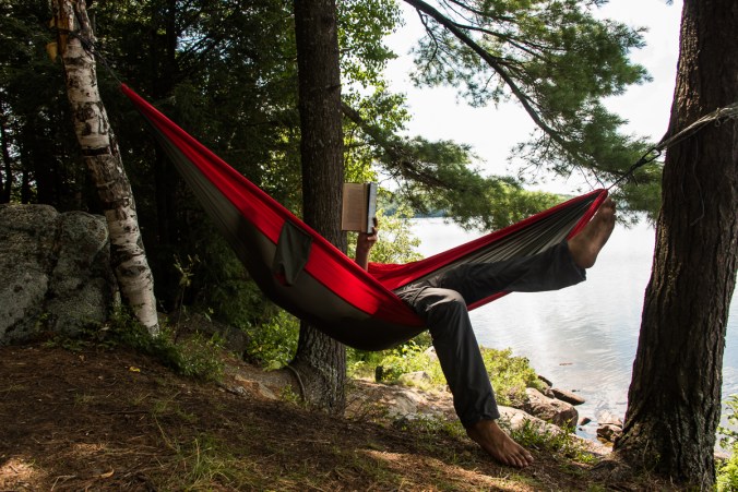 reading a hammock on a campsite on Manitou Lake in Algonquin