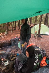 huddling under a tarp in the backcountry