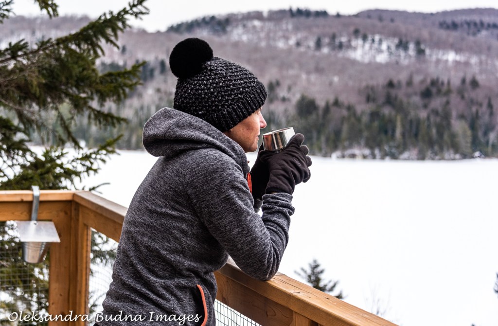 View of a frozen waterfall under Cliff House 18 at Les Refuges Perchés in Quebec